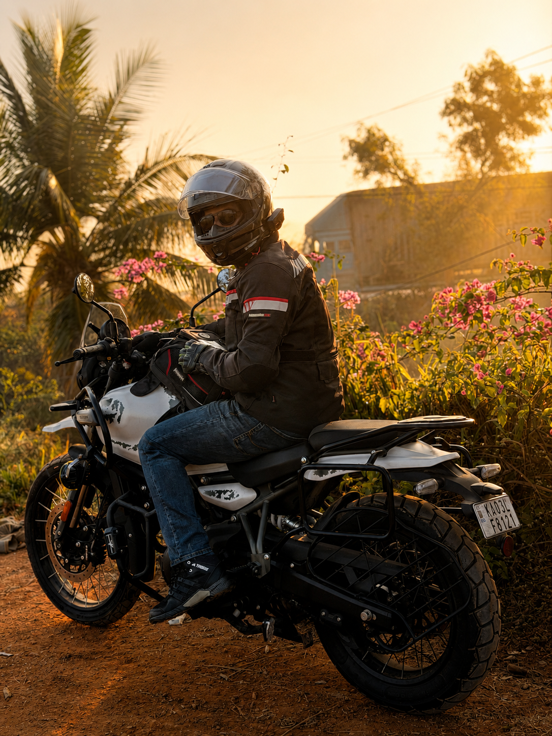 Eldho riding a Royal Enfield Himalayan 411 motorcycle at sunset.